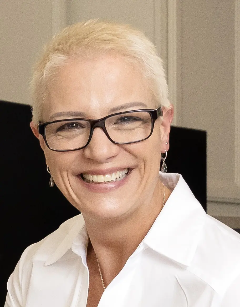 Portrait of Jill Ross, smiling, in a white shirt